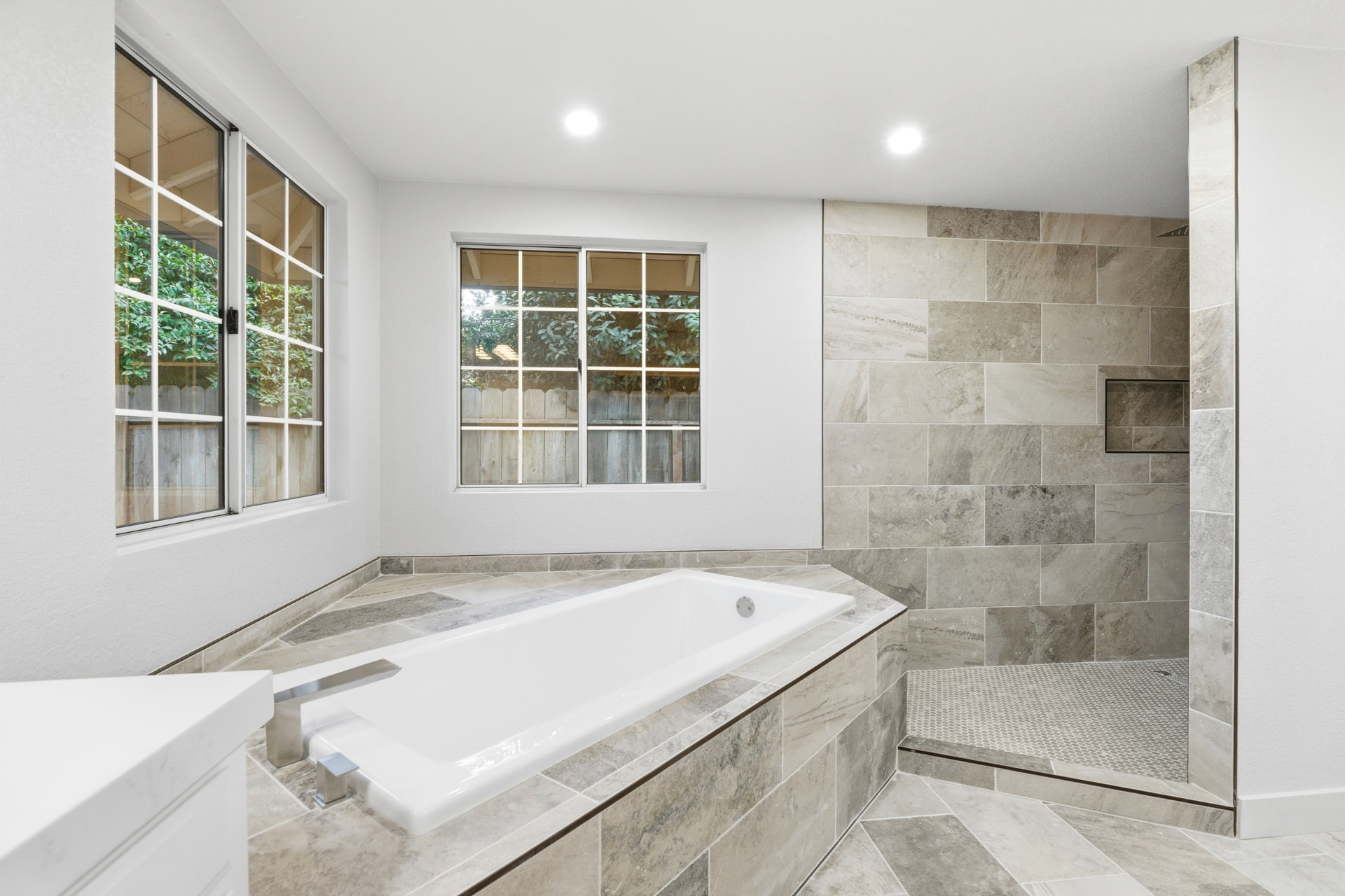 Primary bathroom with soaking tub and walk-in stone shower