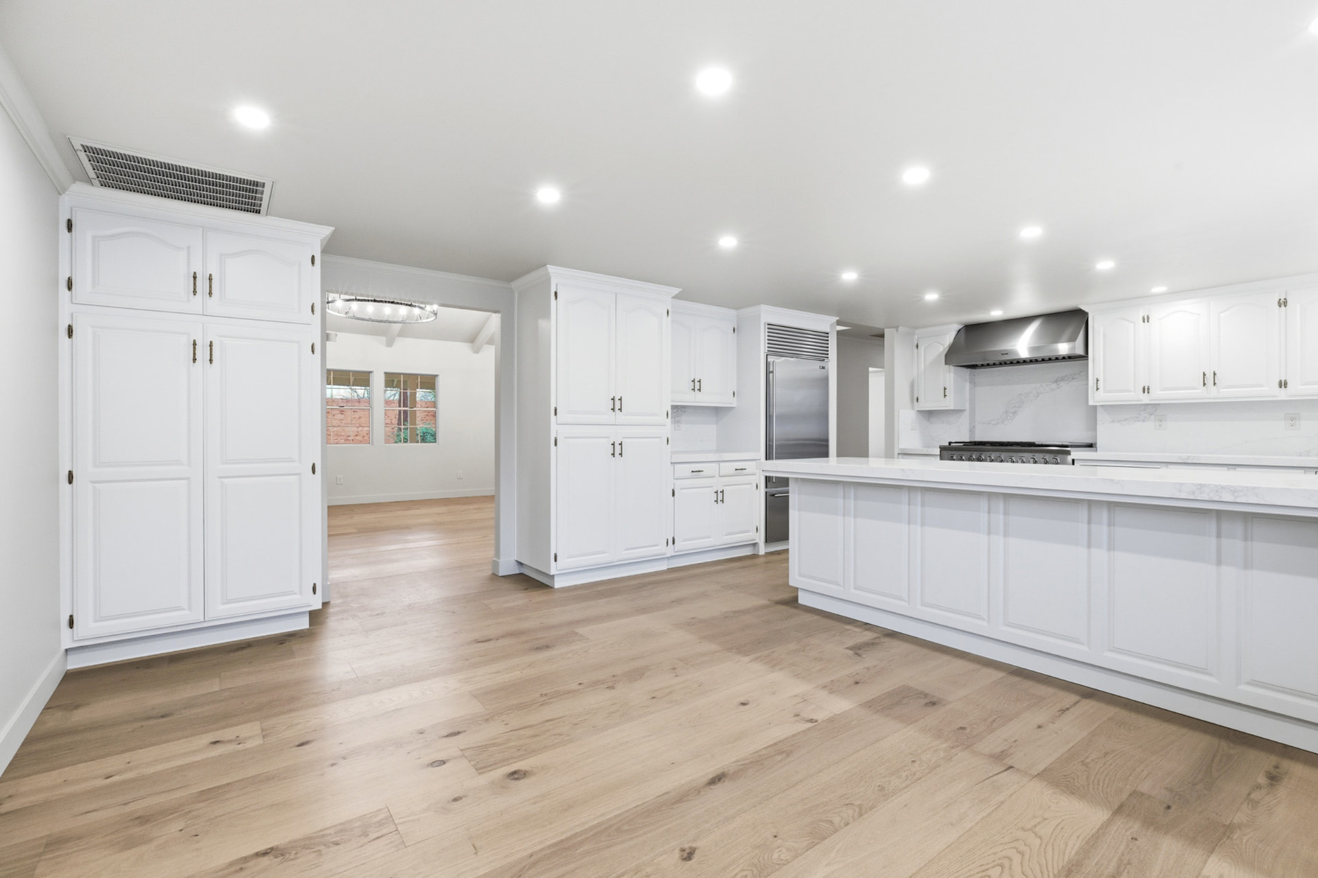 Bright chef's kitchen with a large quartz island and professional appliances